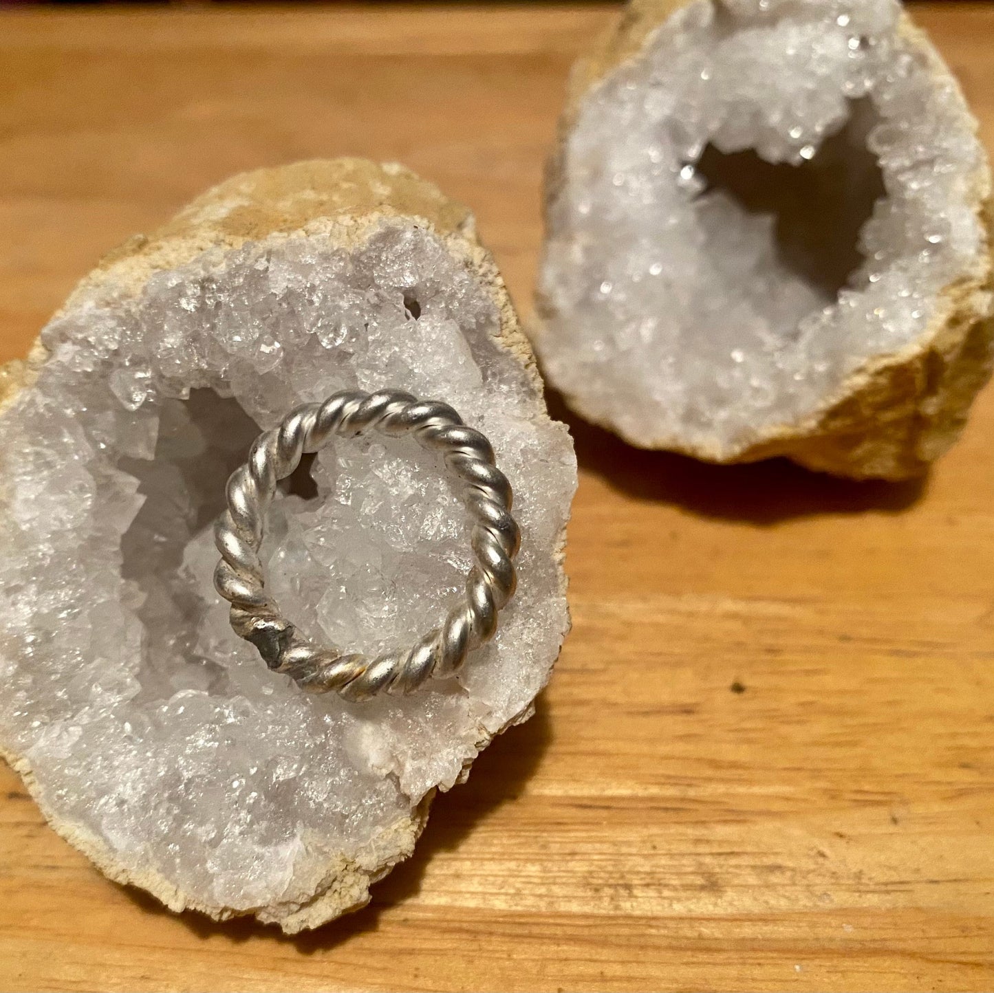 Argentium silver tensor ring sitting on a quartz crystal geode