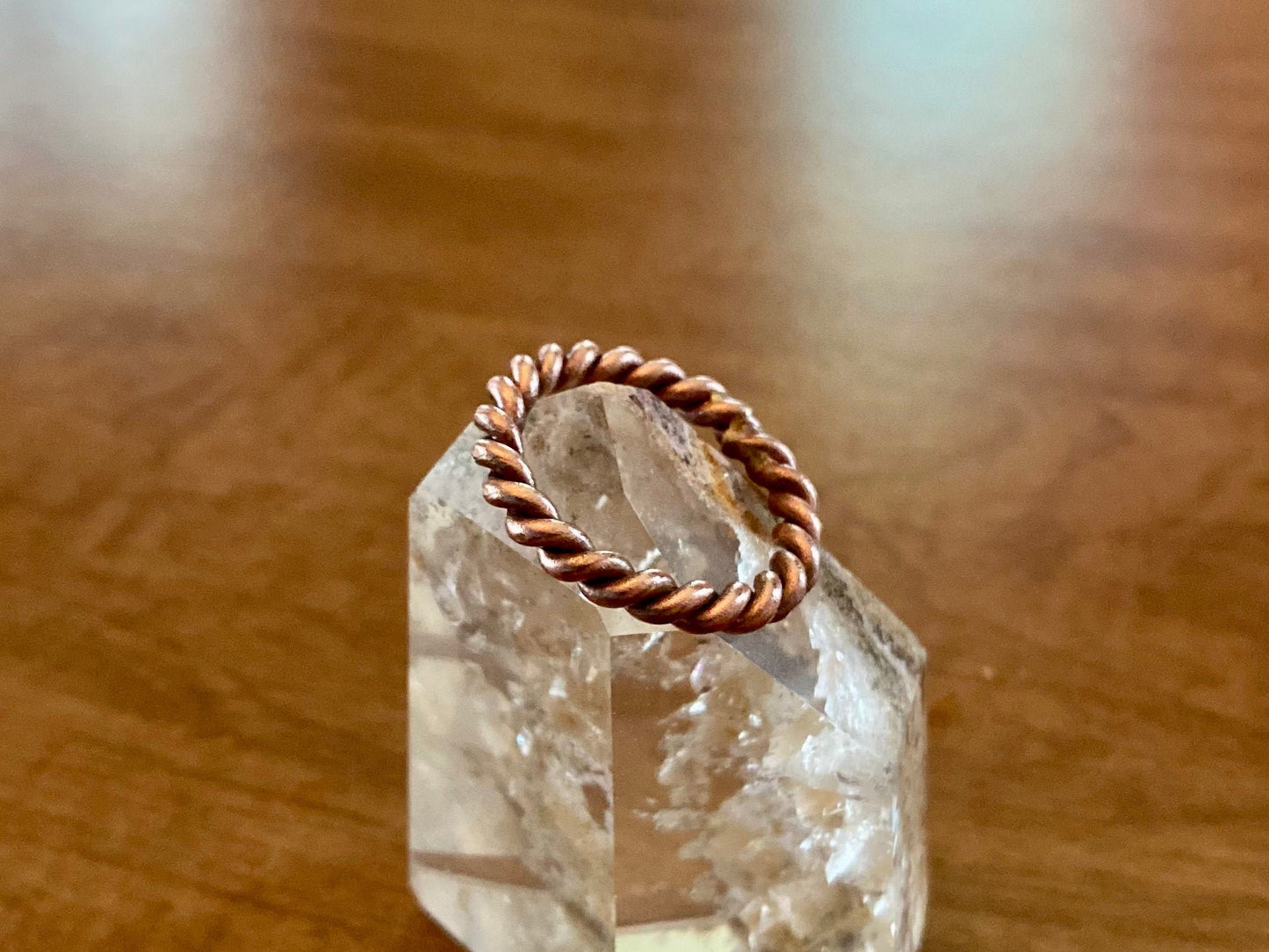 tensor ring finger ring on a clear quartz crystal point