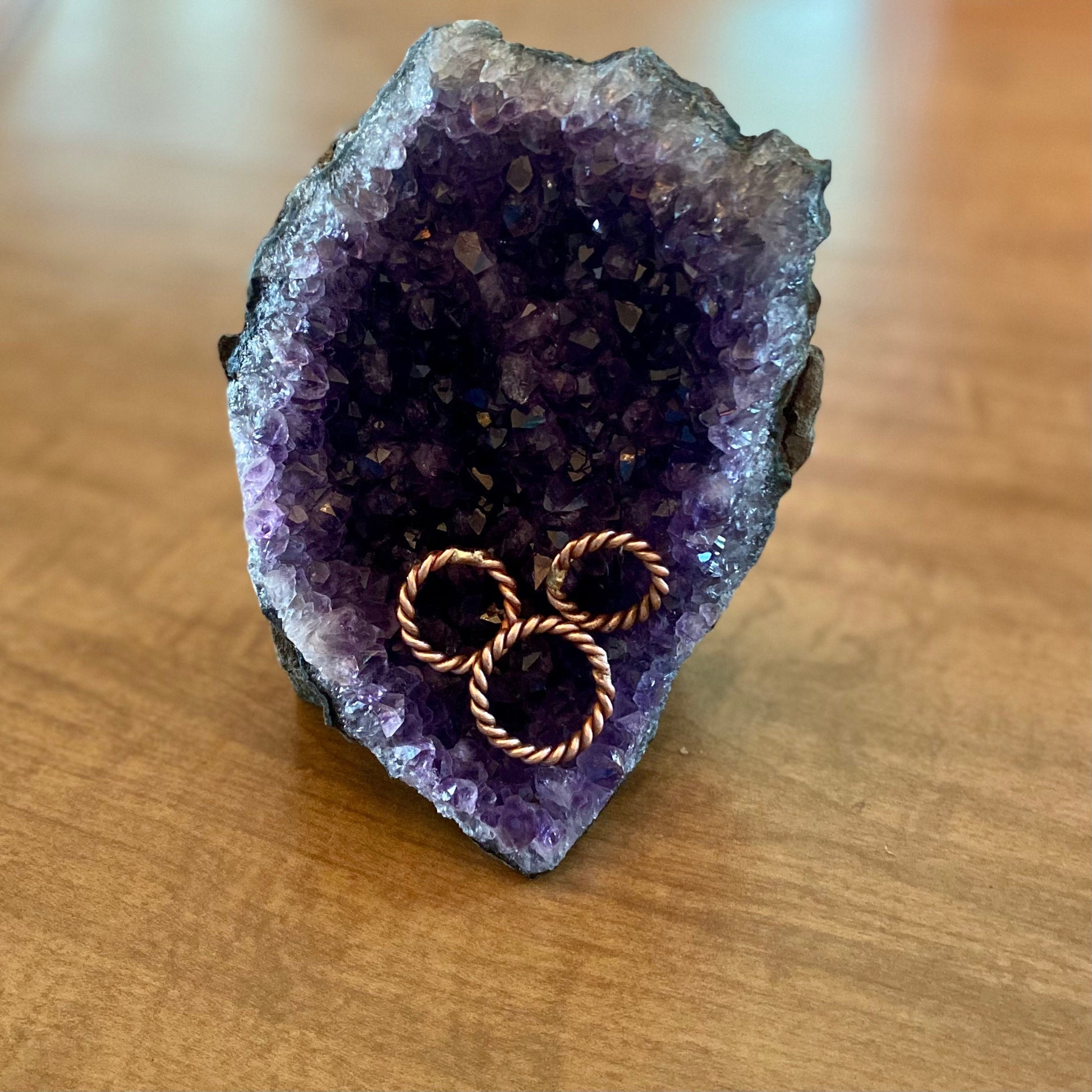 tensor ring finger rings sitting on an amethyst crystal