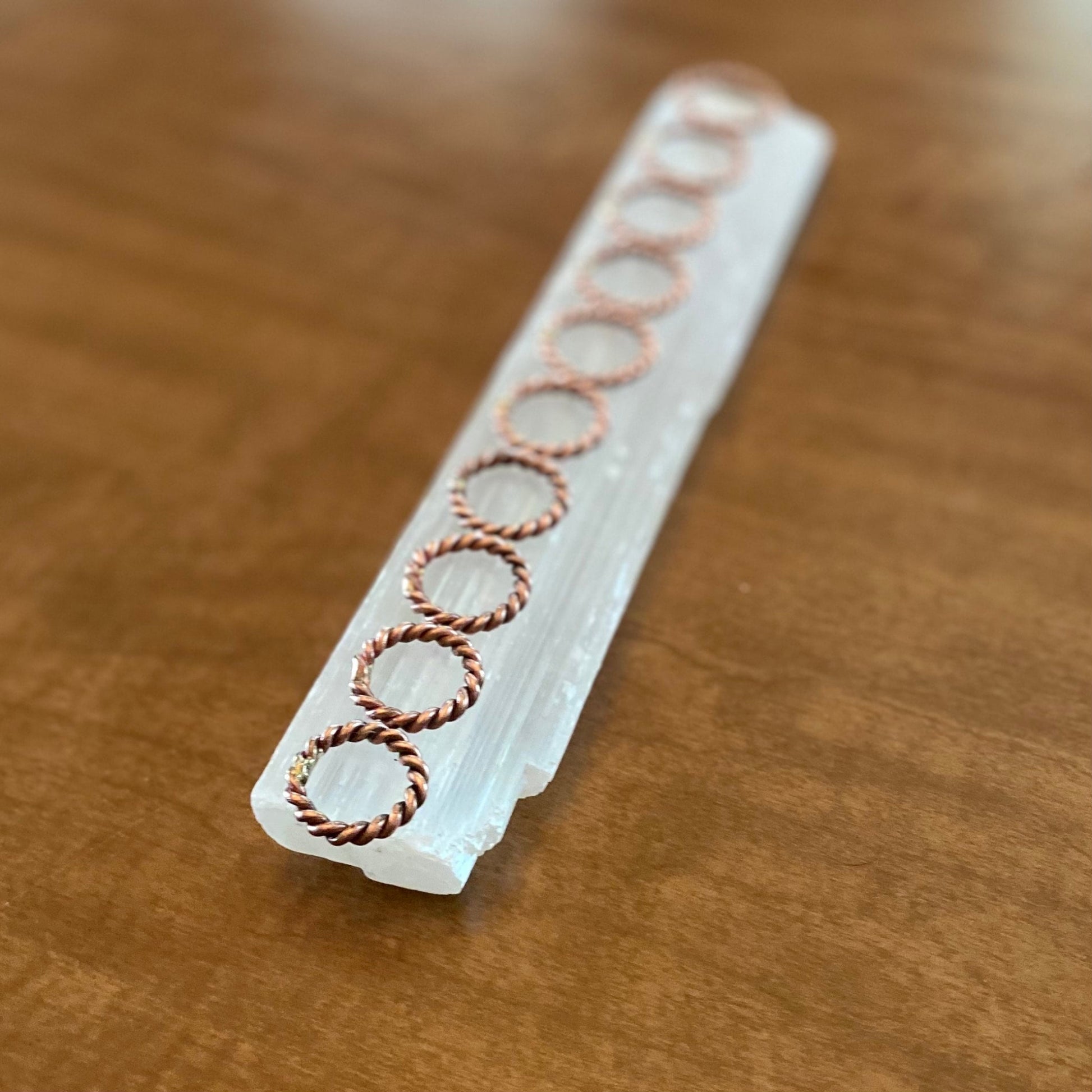 tensor ring finger rings sitting on a selenite crystal